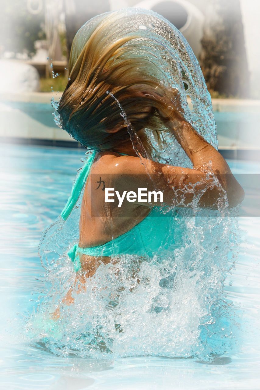 WOMAN SWIMMING IN POOL