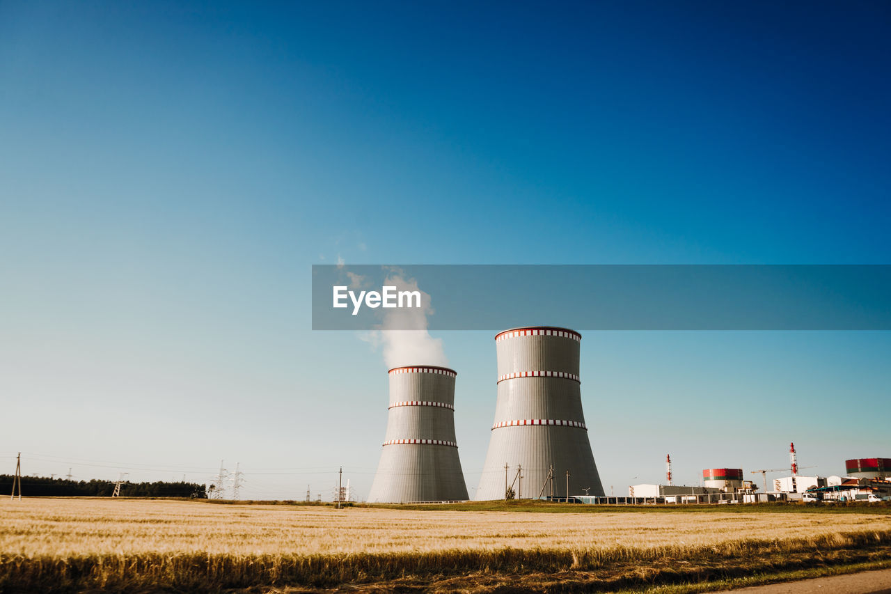 SMOKE STACK ON FACTORY AGAINST SKY