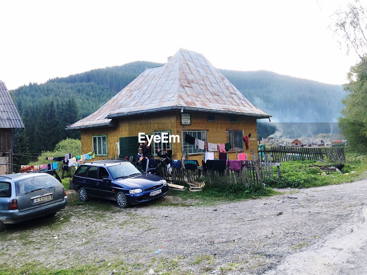 VIEW OF A HOUSE WITH HOUSES IN BACKGROUND