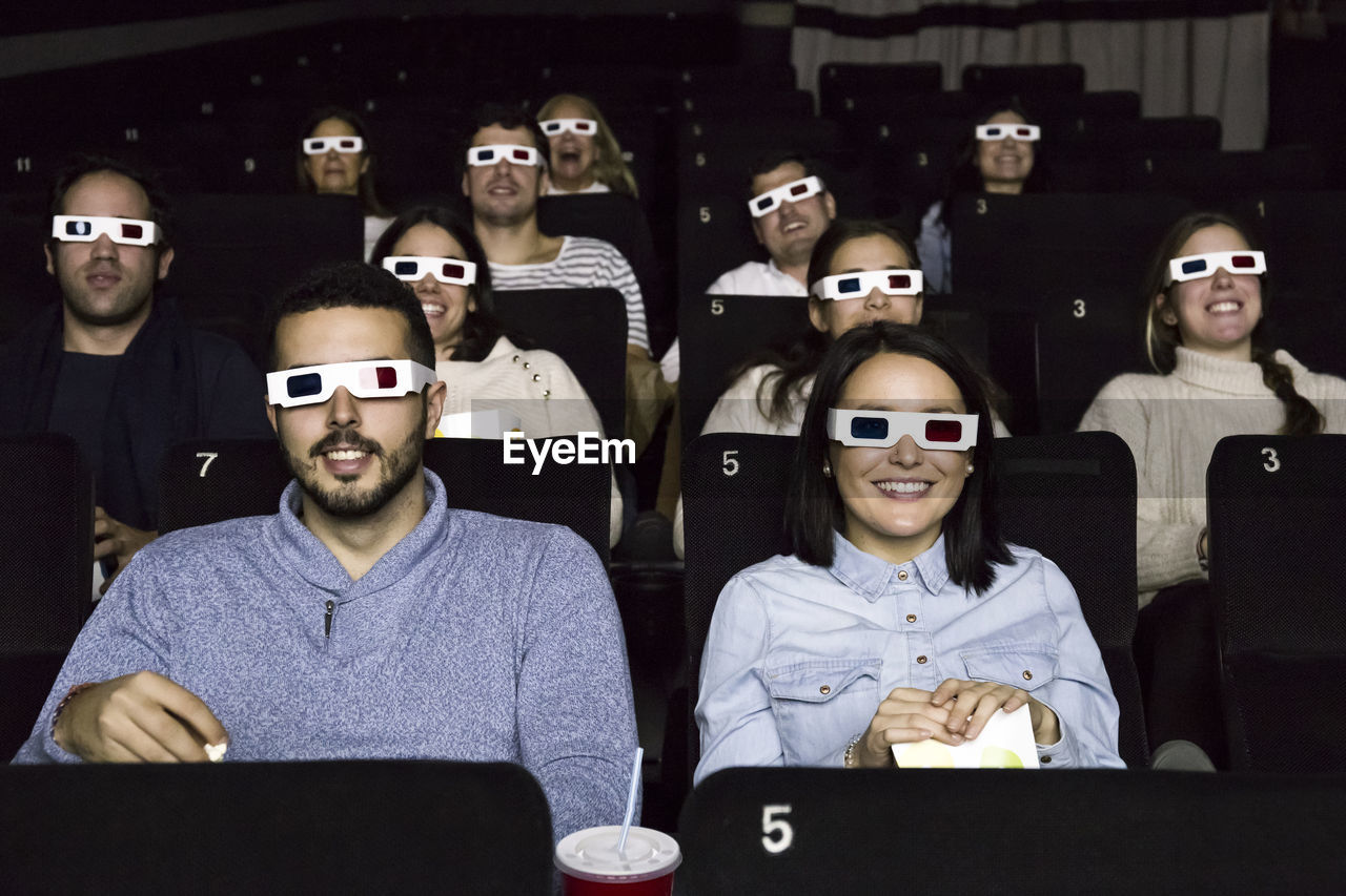 People with 3d glasses watching a movie in a cinema