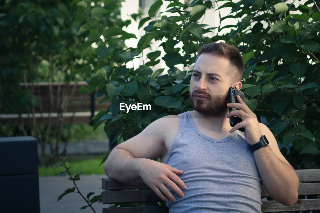 Young man using mobile phone outdoors