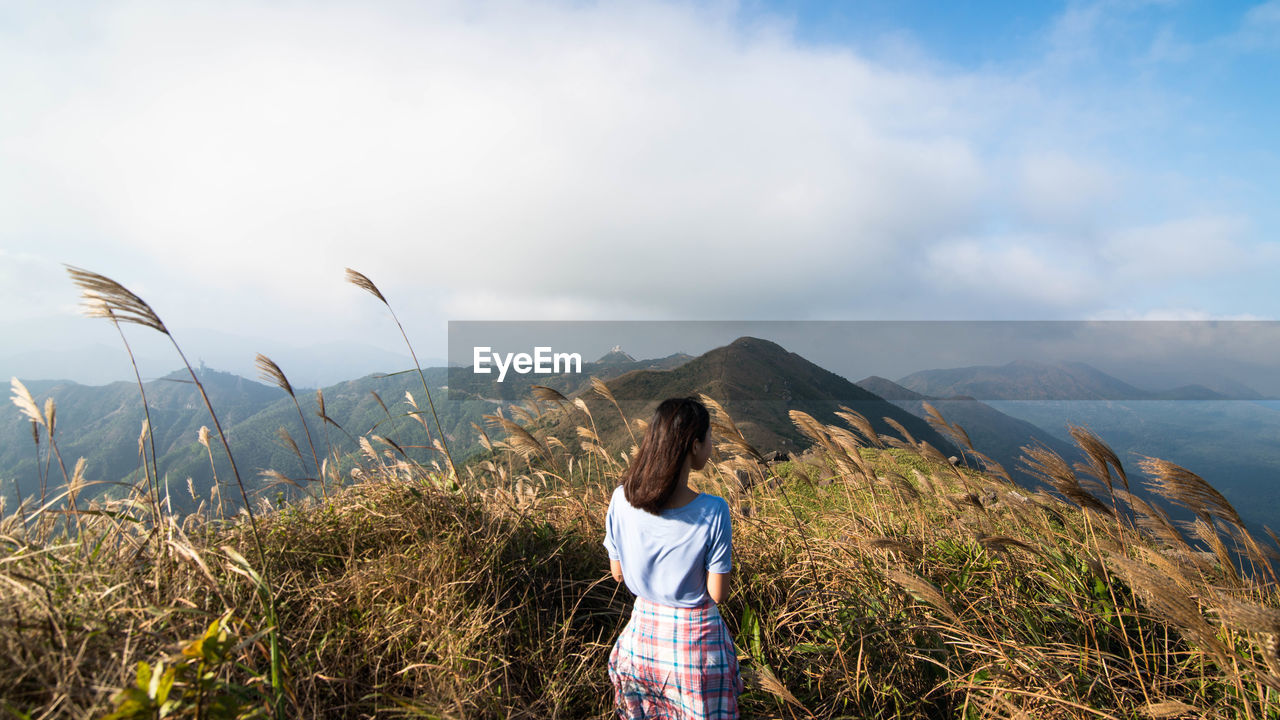 Woman overlooking countryside landscape