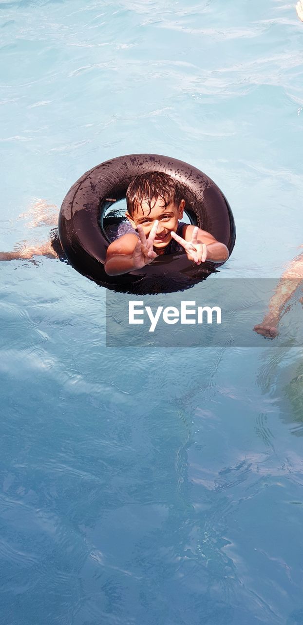 Portrait of boy swimming in pool