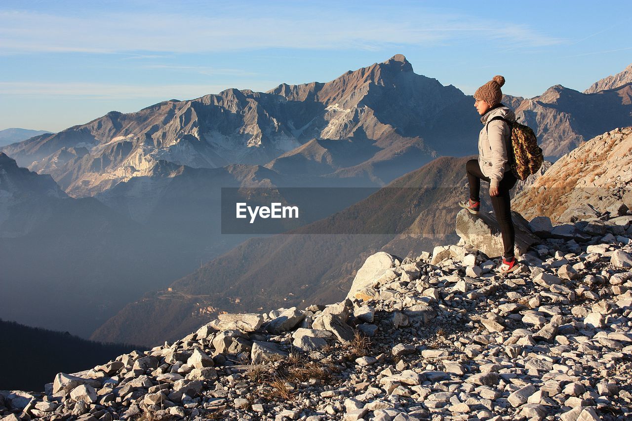 Explorer girl on excursion in mountains of tuscan-emilian apennines. apuan alps on sunny cold day