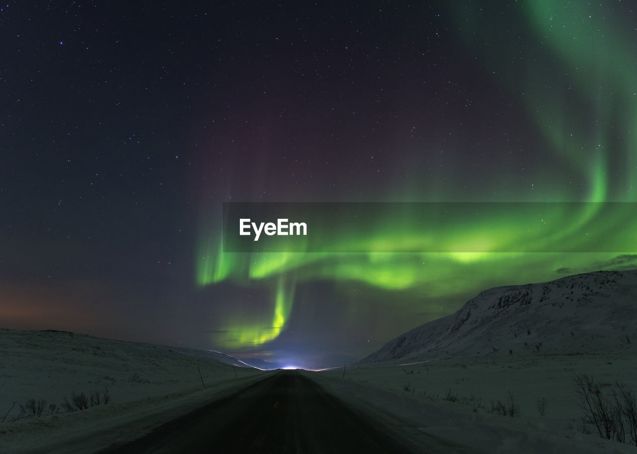 Scenic view of aurora borealis against sky at night