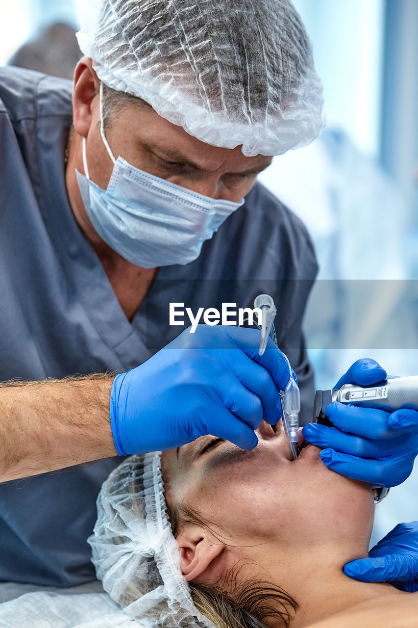 midsection of doctor examining patient at clinic