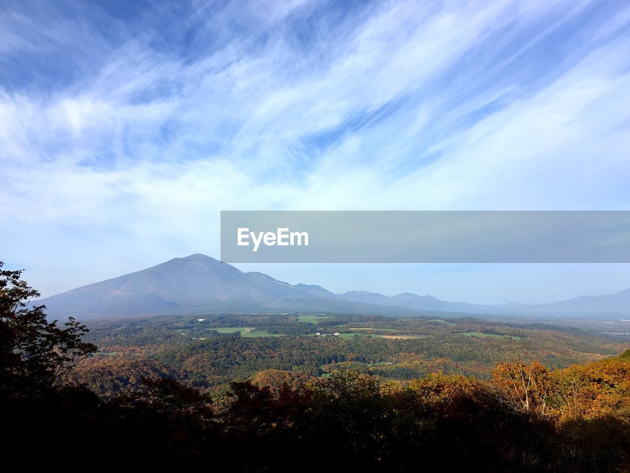 Scenic view of countryside landscape against blue sky