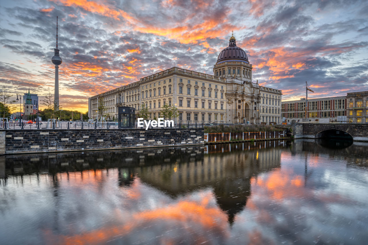 The reconstructed berlin city palace with the television tower before sunrise