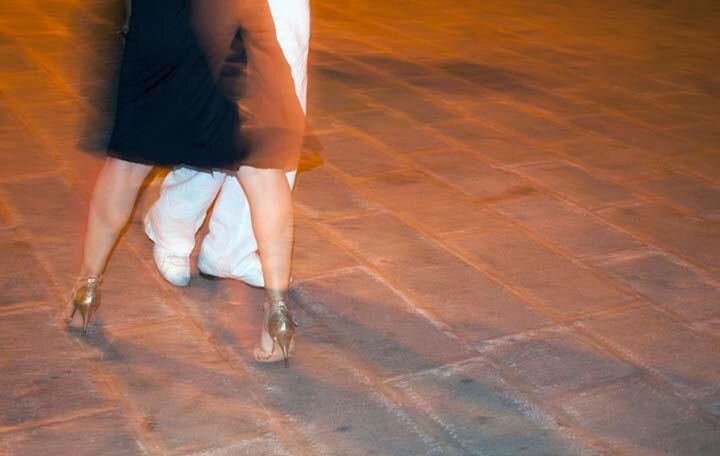 LOW SECTION OF WOMAN STANDING ON TILED FLOOR