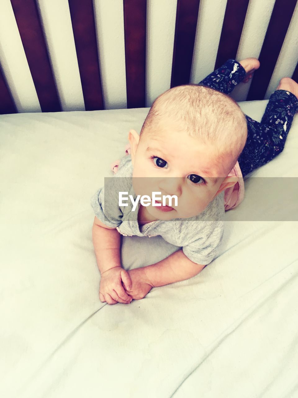 High angle portrait of baby on bed at home