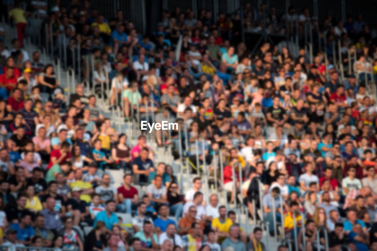 Defocused image of people cheering at stadium