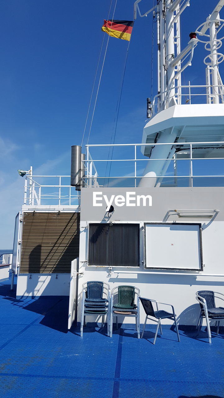 Low angle view of german flag waving on ferry against sky