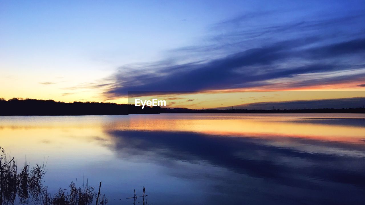 SCENIC VIEW OF SUNSET OVER LAKE