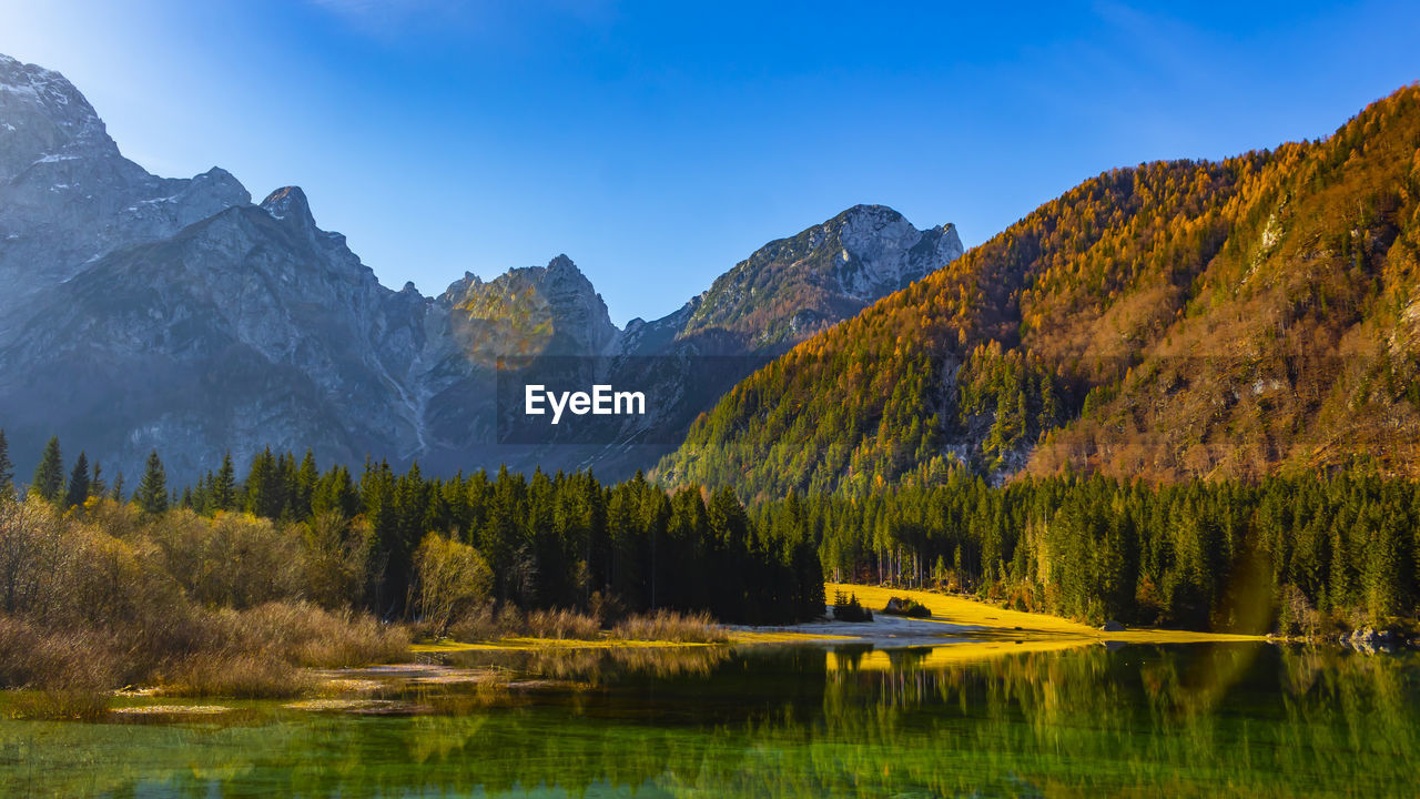 Scenic view of lake and mountains against sky