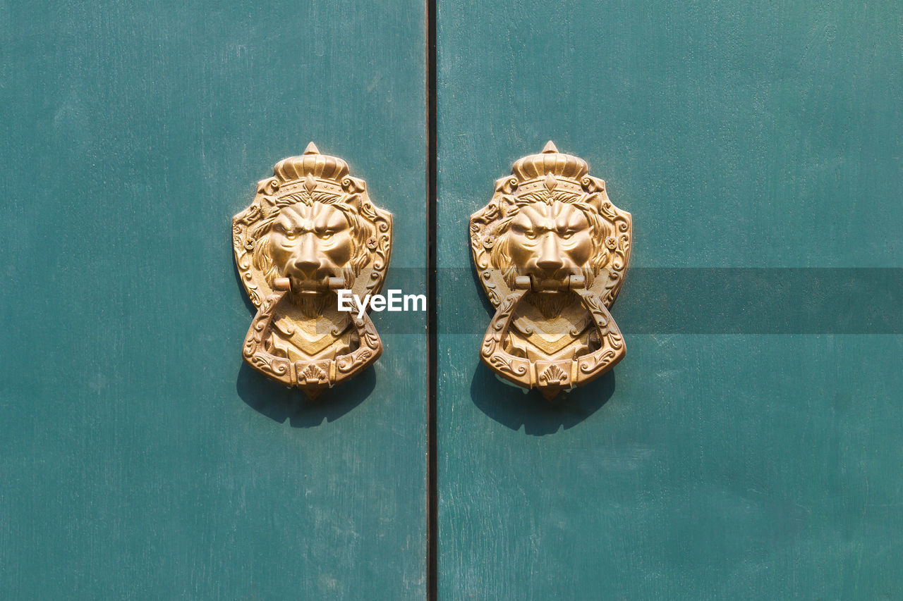 Close-up of knockers on door