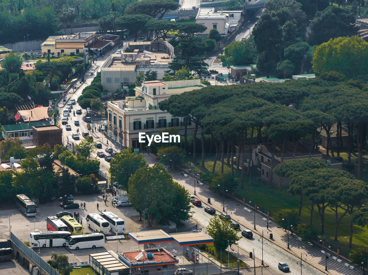 architecture, aerial photography, bird's-eye view, city, built structure, high angle view, town, building exterior, tree, plant, building, residential area, transportation, cityscape, road, nature, street, neighbourhood, residential district, suburb, aerial view, mode of transportation, car, motor vehicle, house, no people, day, outdoors, city street, landscape, environment, travel, roof, land vehicle, urban area, travel destinations, land, sunlight, city life
