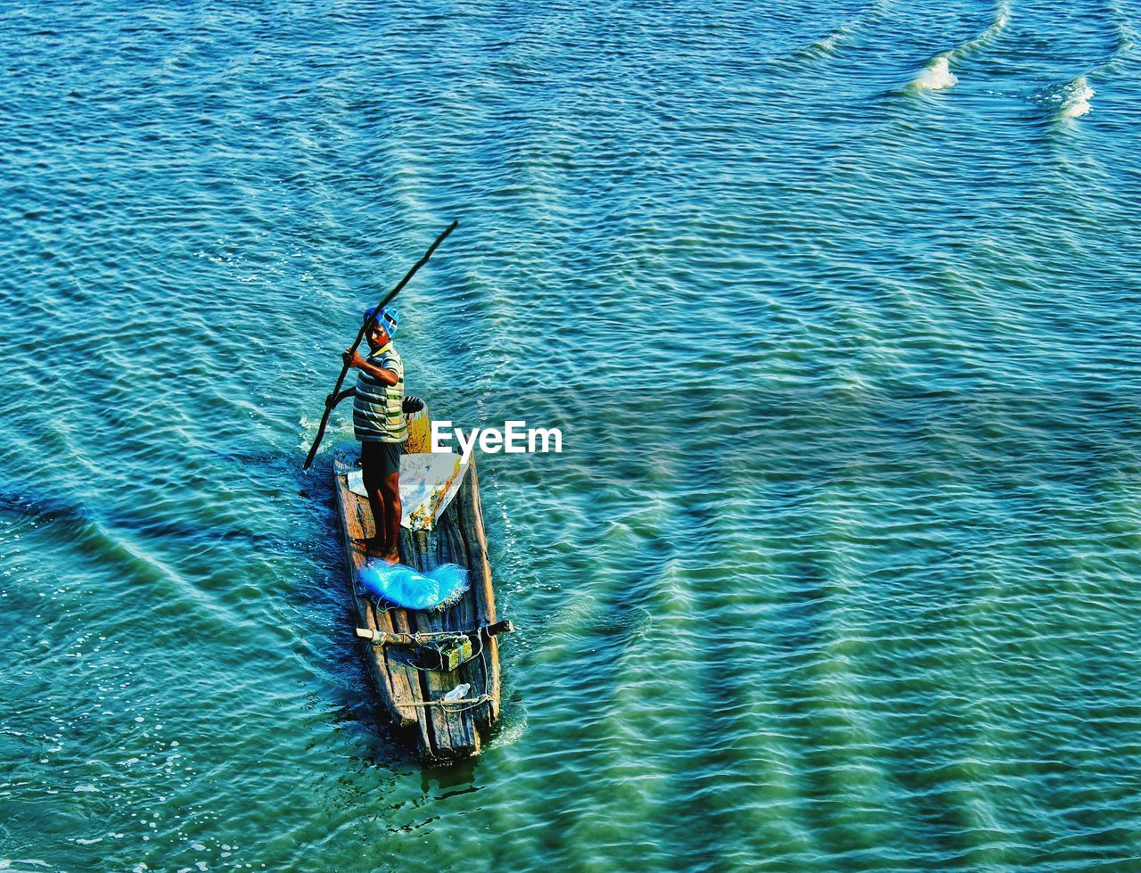High angle view of man rowing boat in sea