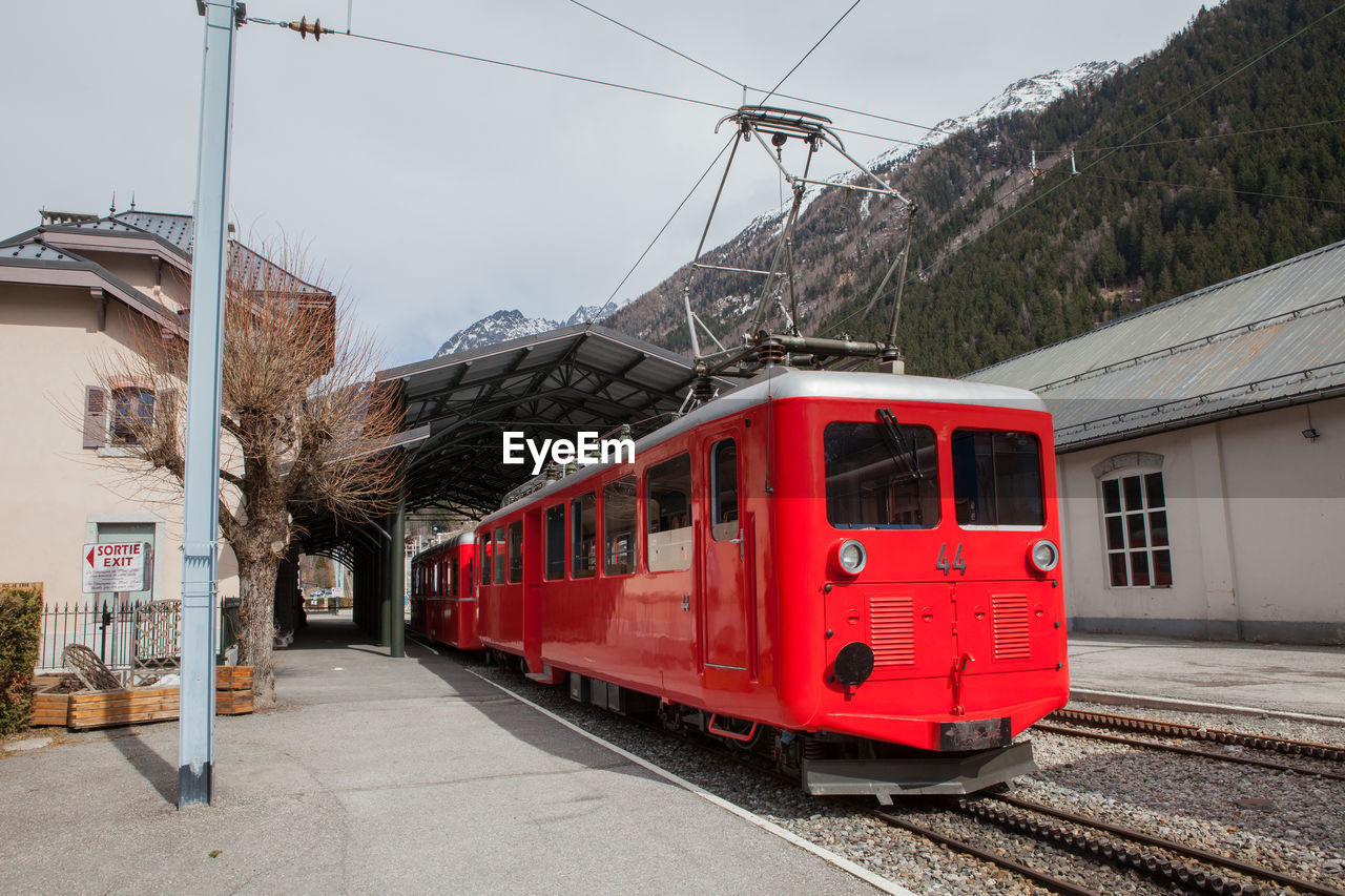 Train at platform with mountain in background