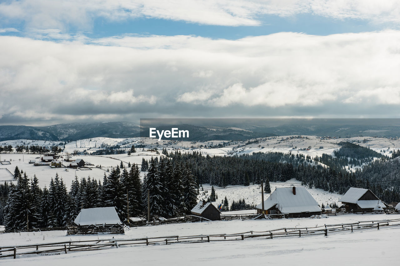 Scenic view of snowcapped landscape against sky during winter