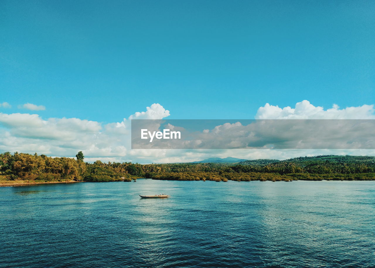 PANORAMIC VIEW OF SEA AGAINST BLUE SKY