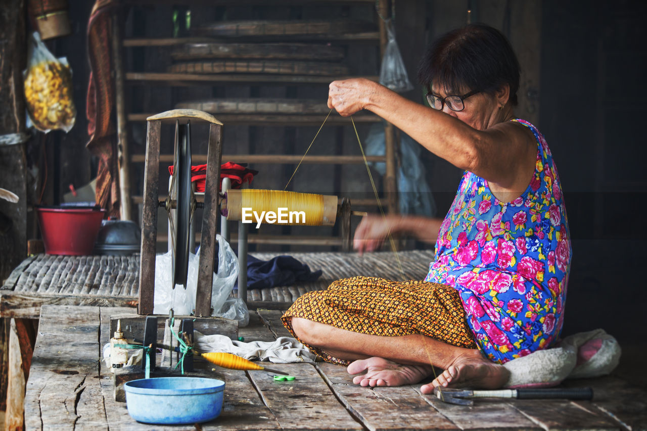 Woman working on loom