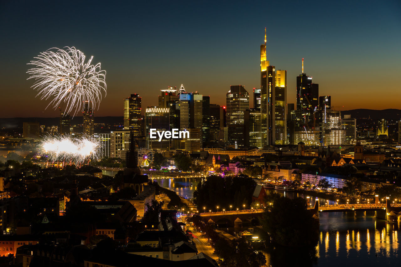 Fireworks mainfest frankfurt in front of illuminated city skyline