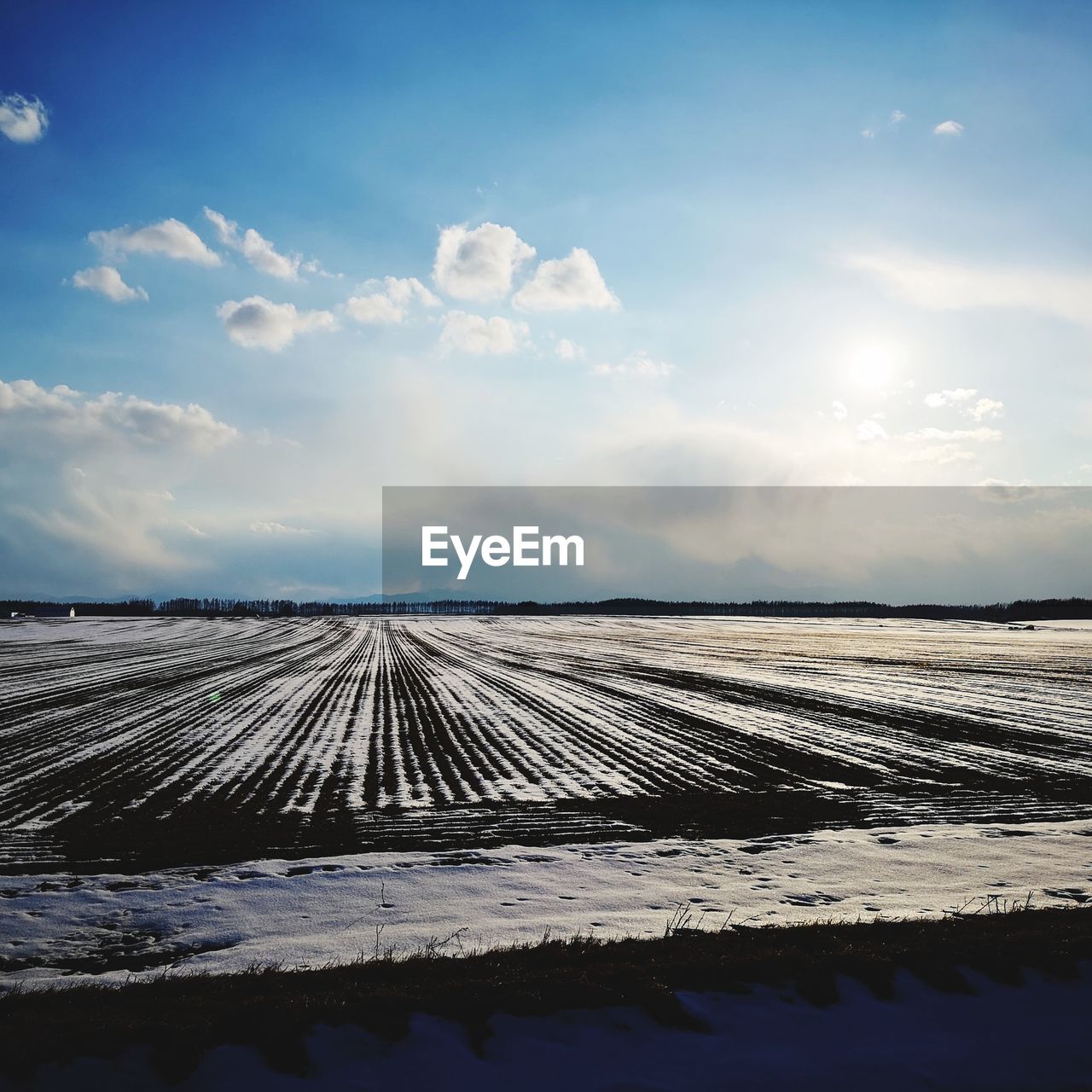 SNOW COVERED LAND AGAINST SKY