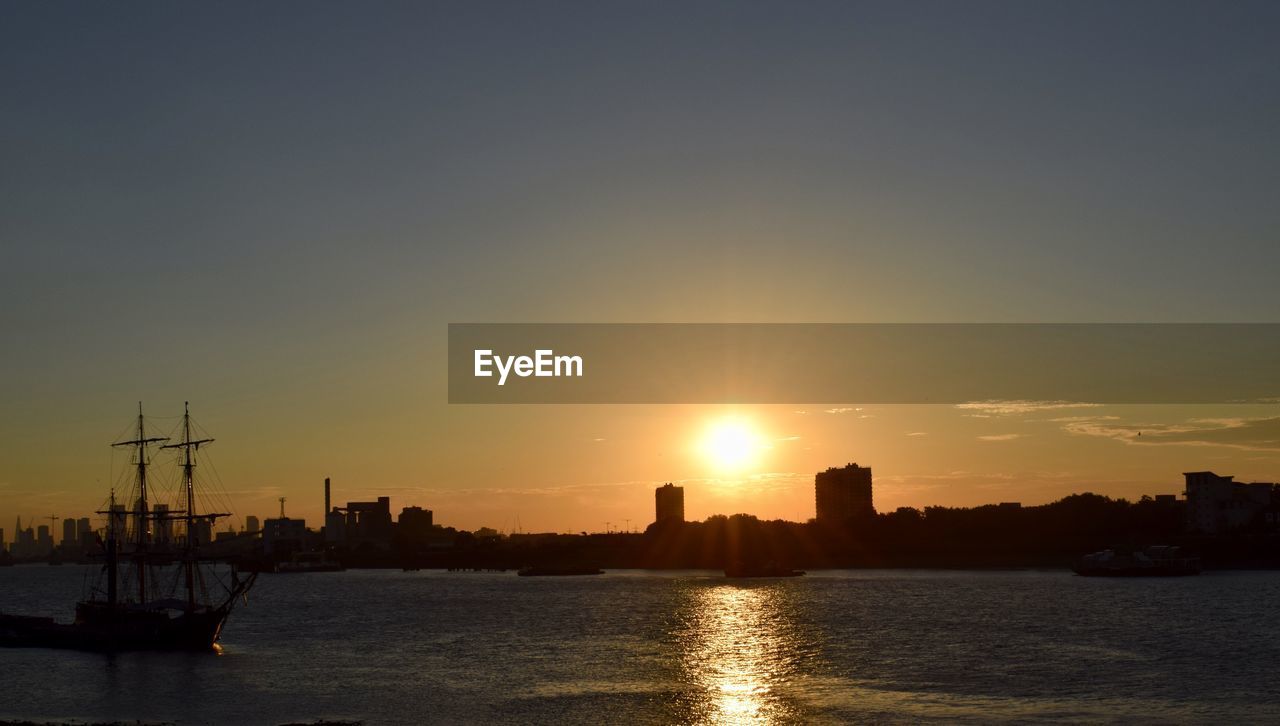 SILHOUETTE OF CITY AT WATERFRONT