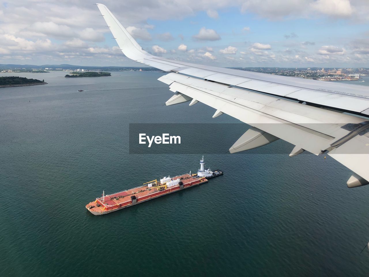 Airliner window view of passing ship