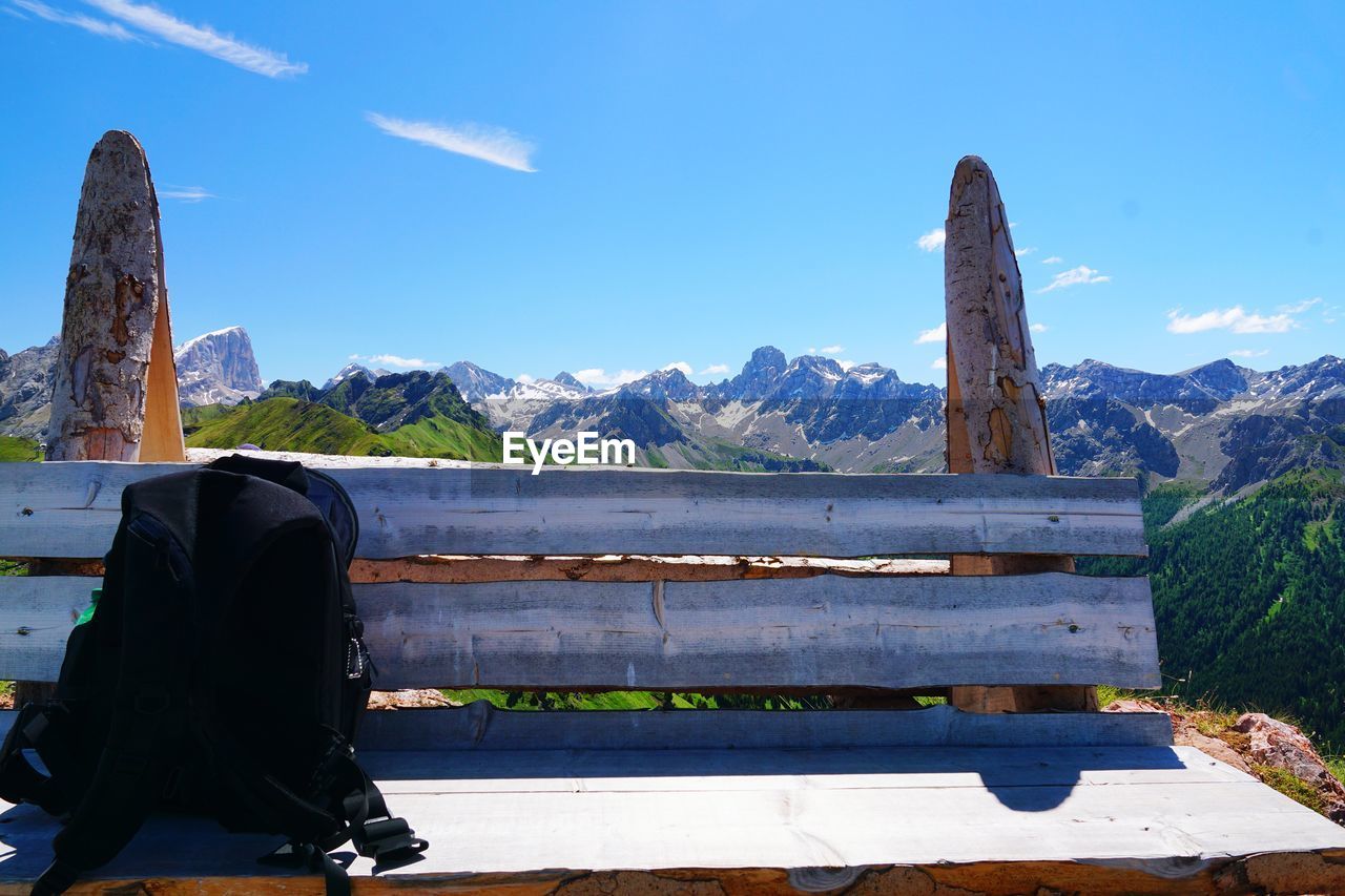 MAN SITTING ON BENCH LOOKING AT VIEW