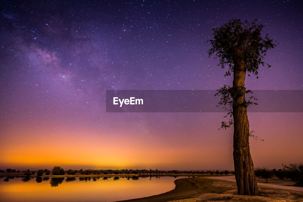 Scenic view of lake against sky at dusk