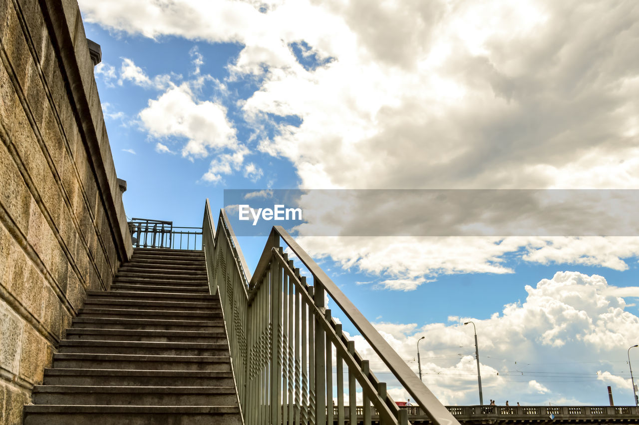 Low angle view of steps by wall