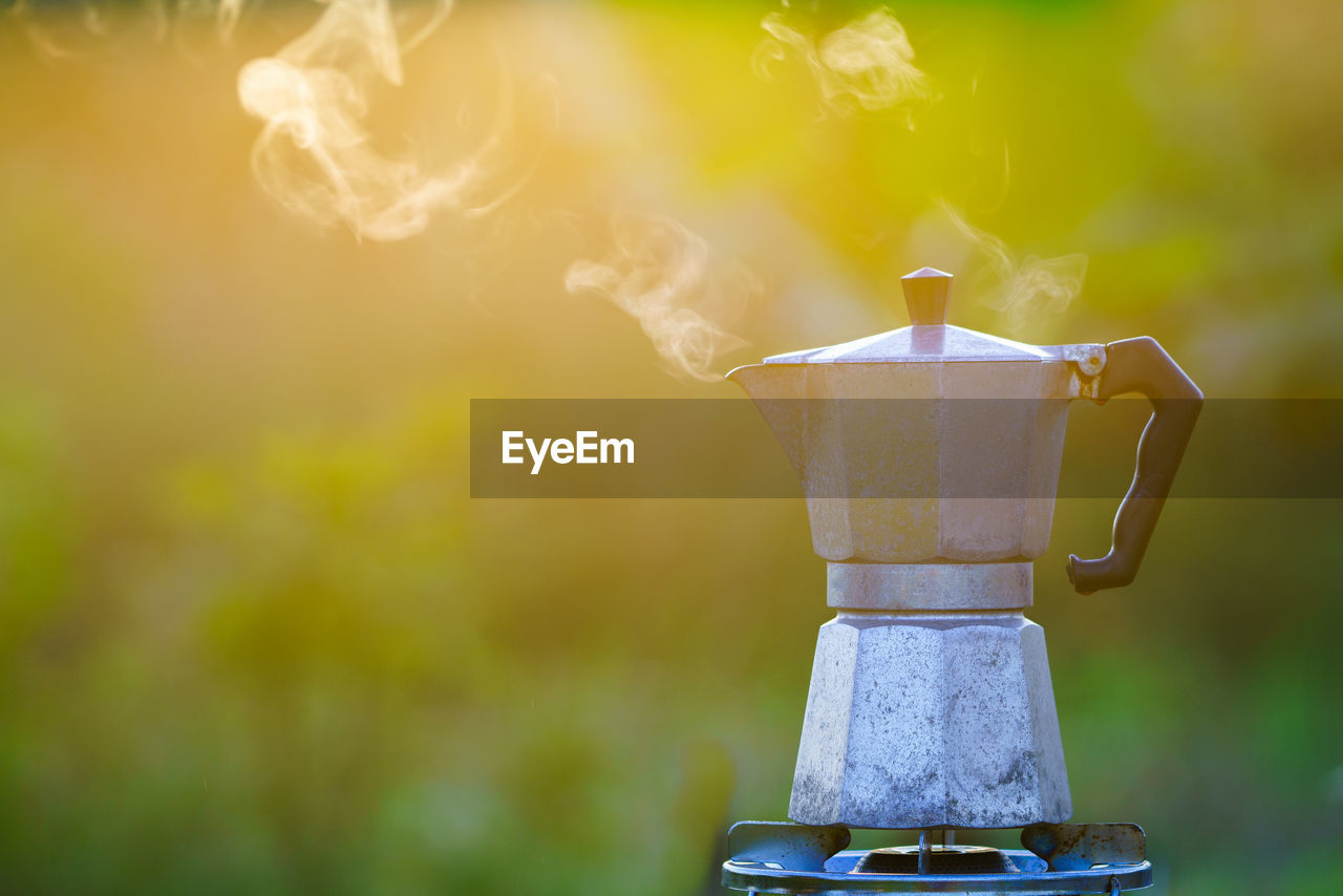 Antique coffee pot on the gas stove for camping when the sun rises in the morning.