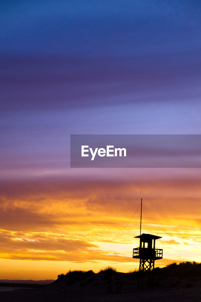 Scenic view of silhouette field against sky during sunset