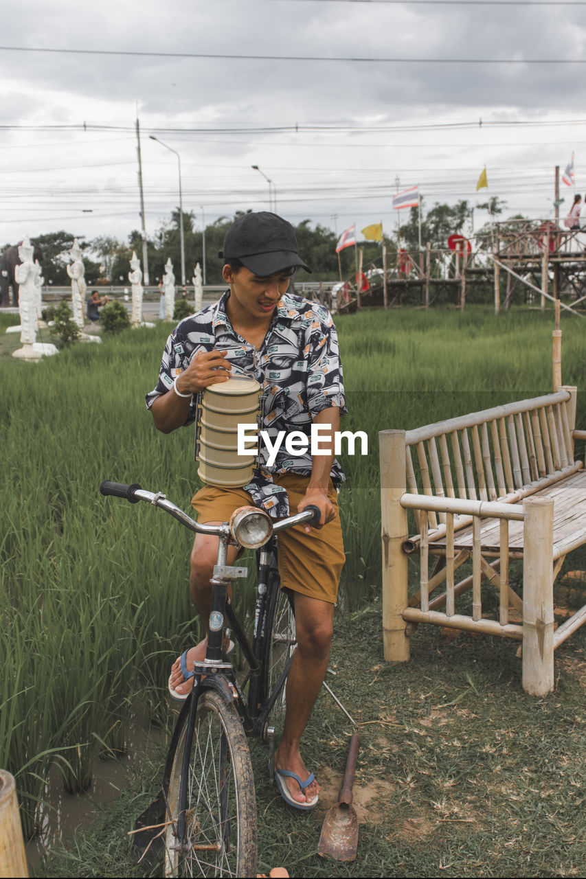 Boy riding bicycle on field
