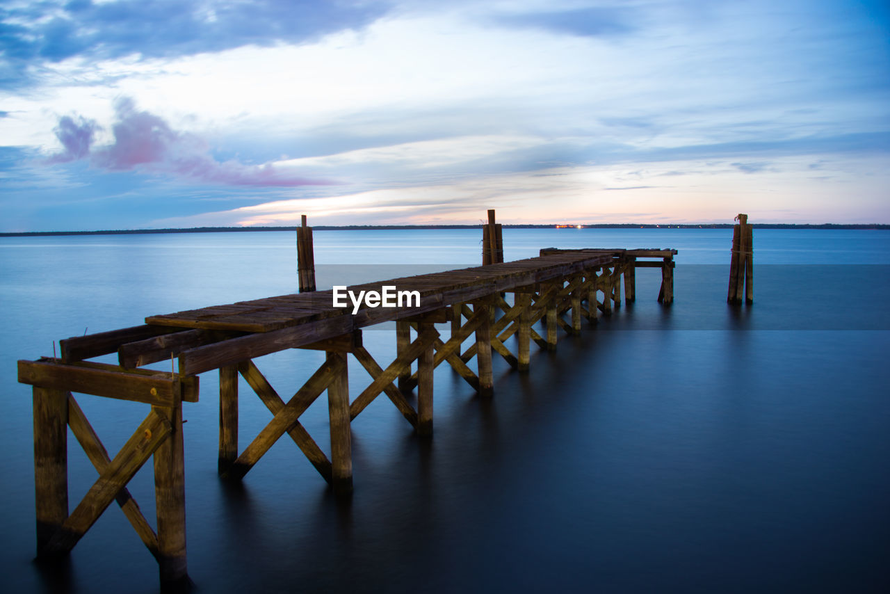 WOODEN PIER OVER SEA AGAINST SKY