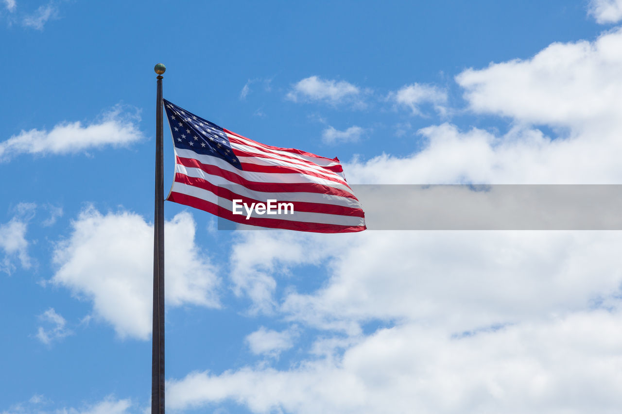 Low angle view of flag against sky