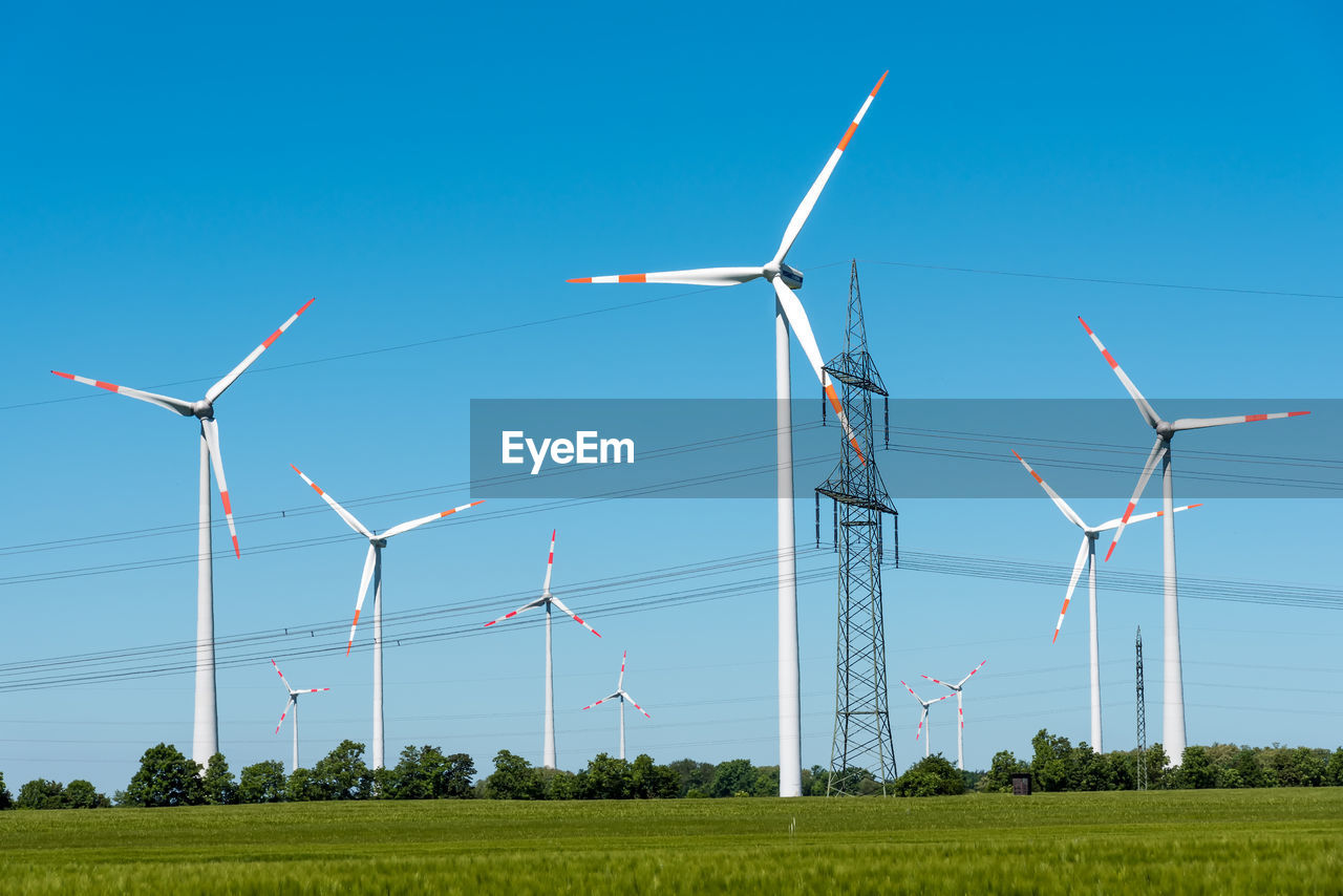 Power supply lines and wind turbines seen in rural germany