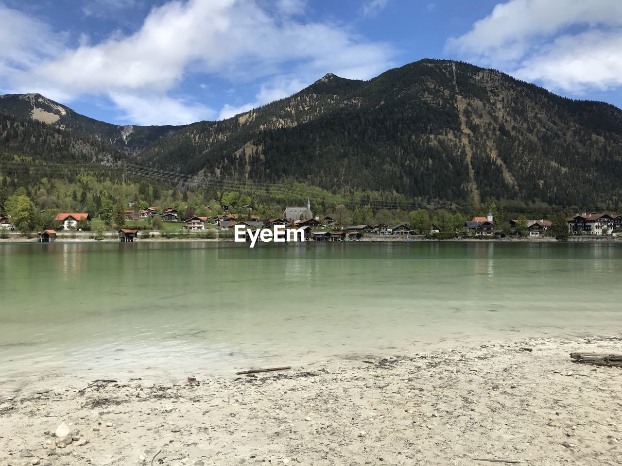 SAILBOATS IN LAKE AGAINST SKY