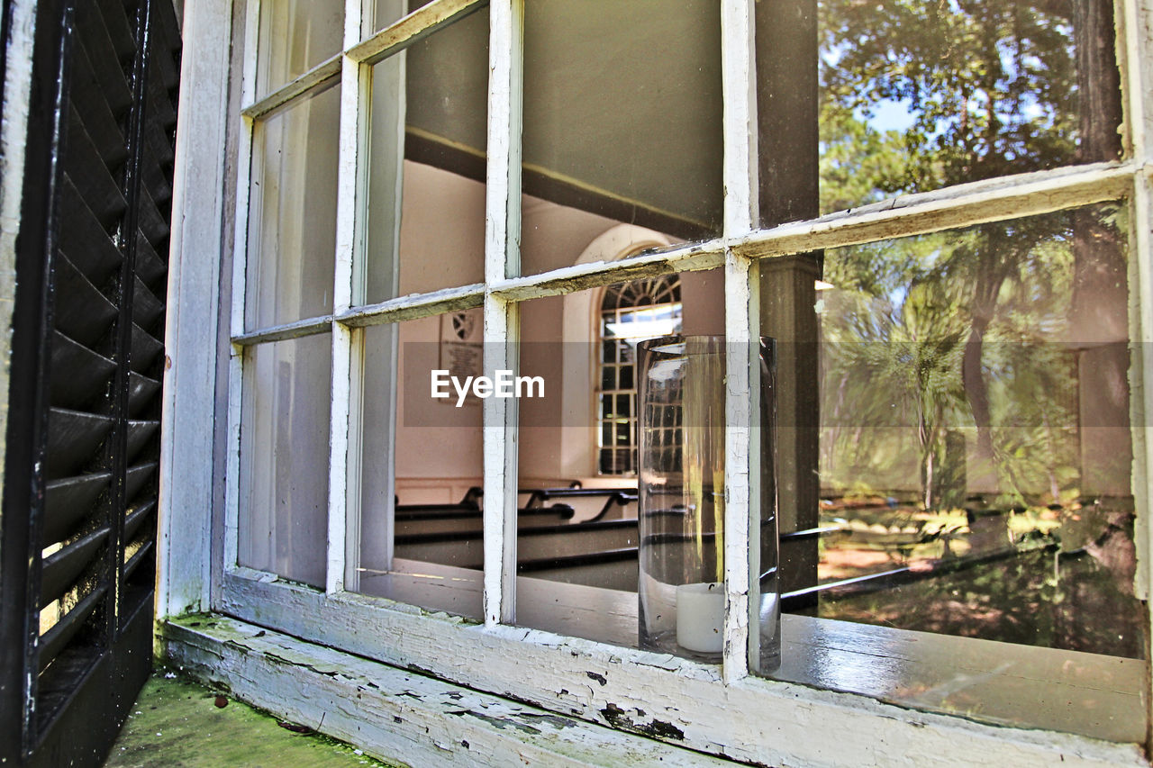 HOUSE SEEN THROUGH WINDOWS