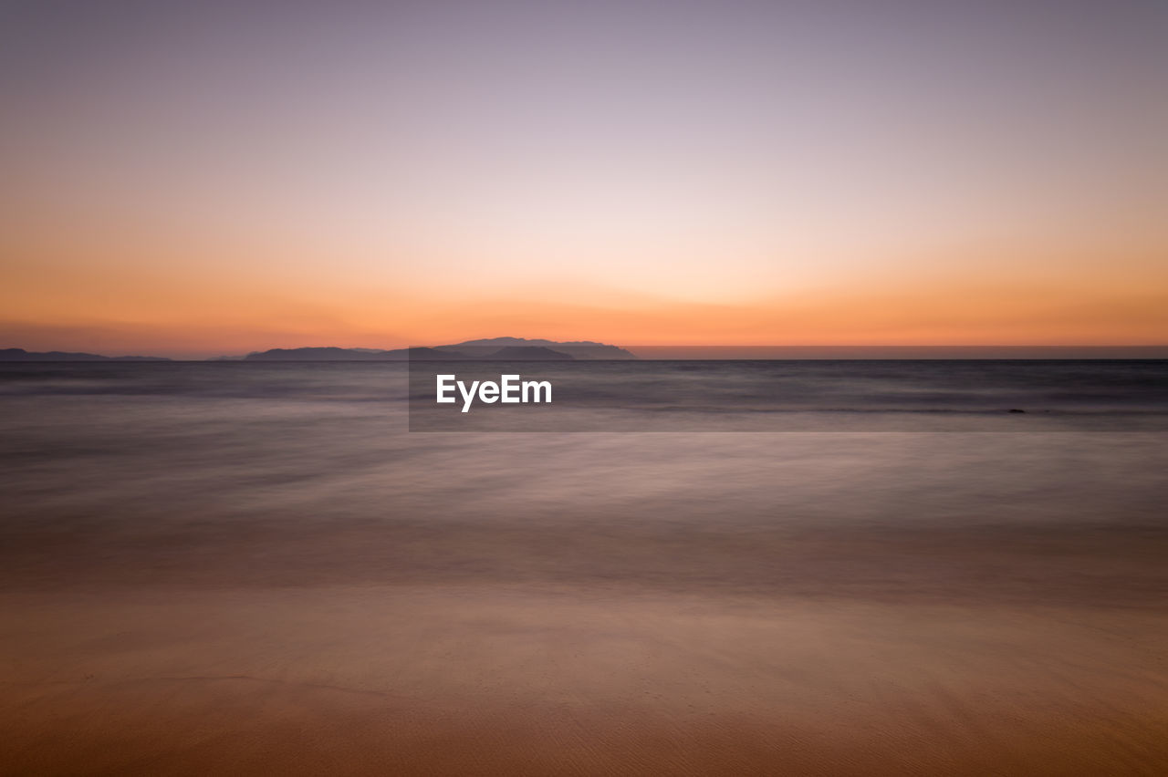 Scenic view of sea at sunset