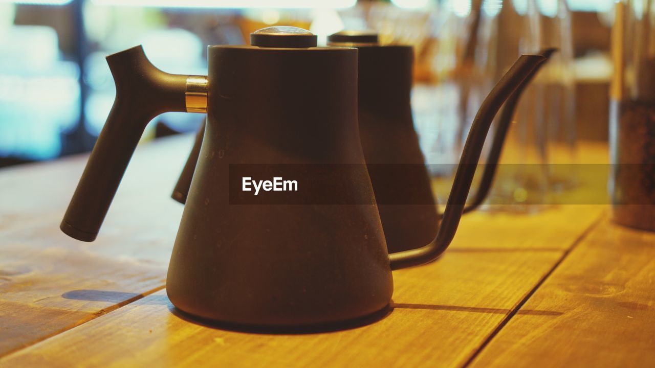 Close-up of teapots on table