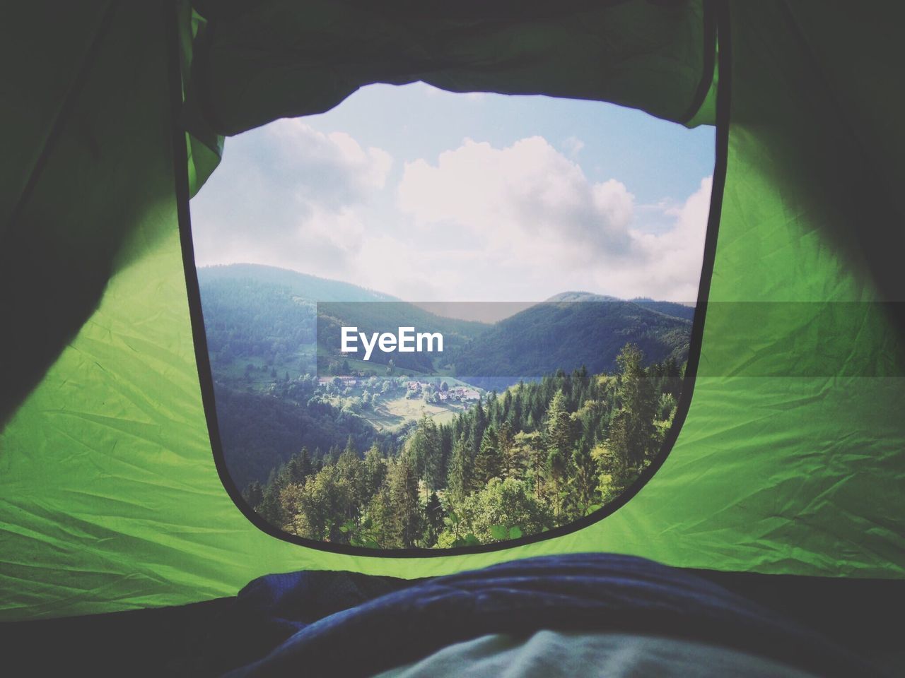 Idyllic view of mountains against sky seen through tent