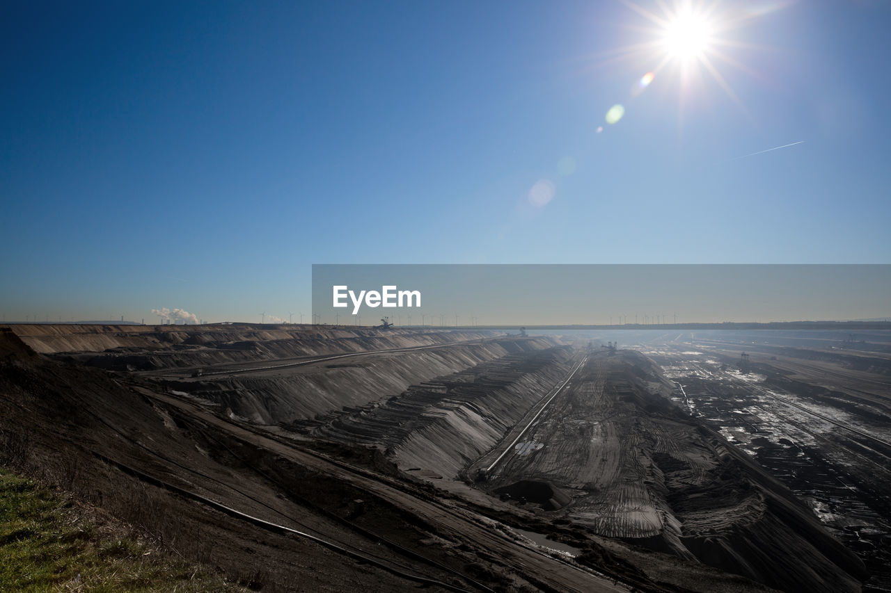 SCENIC VIEW OF BRIGHT SUN OVER LAND