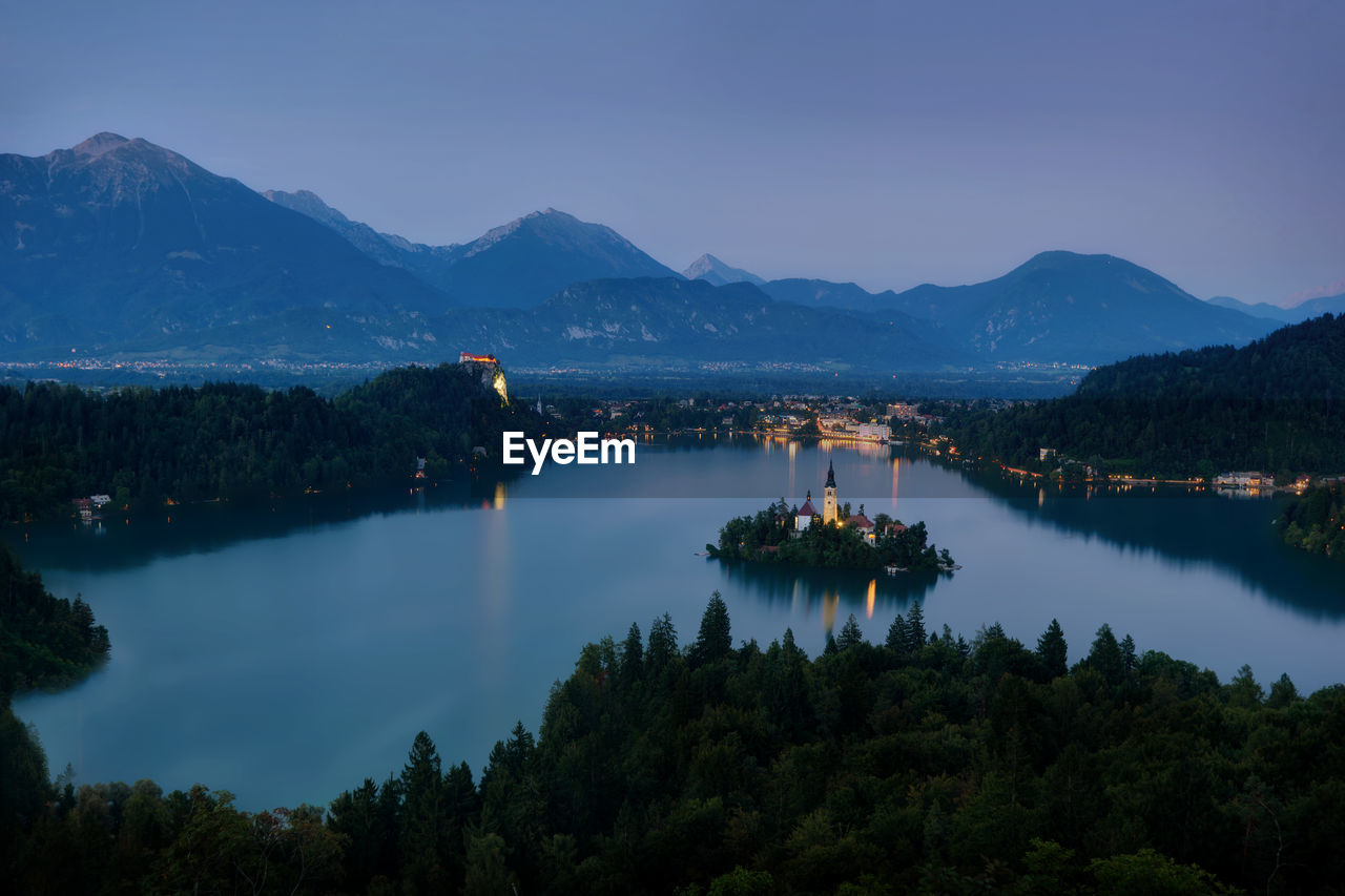 Scenic view of lake and mountains against sky