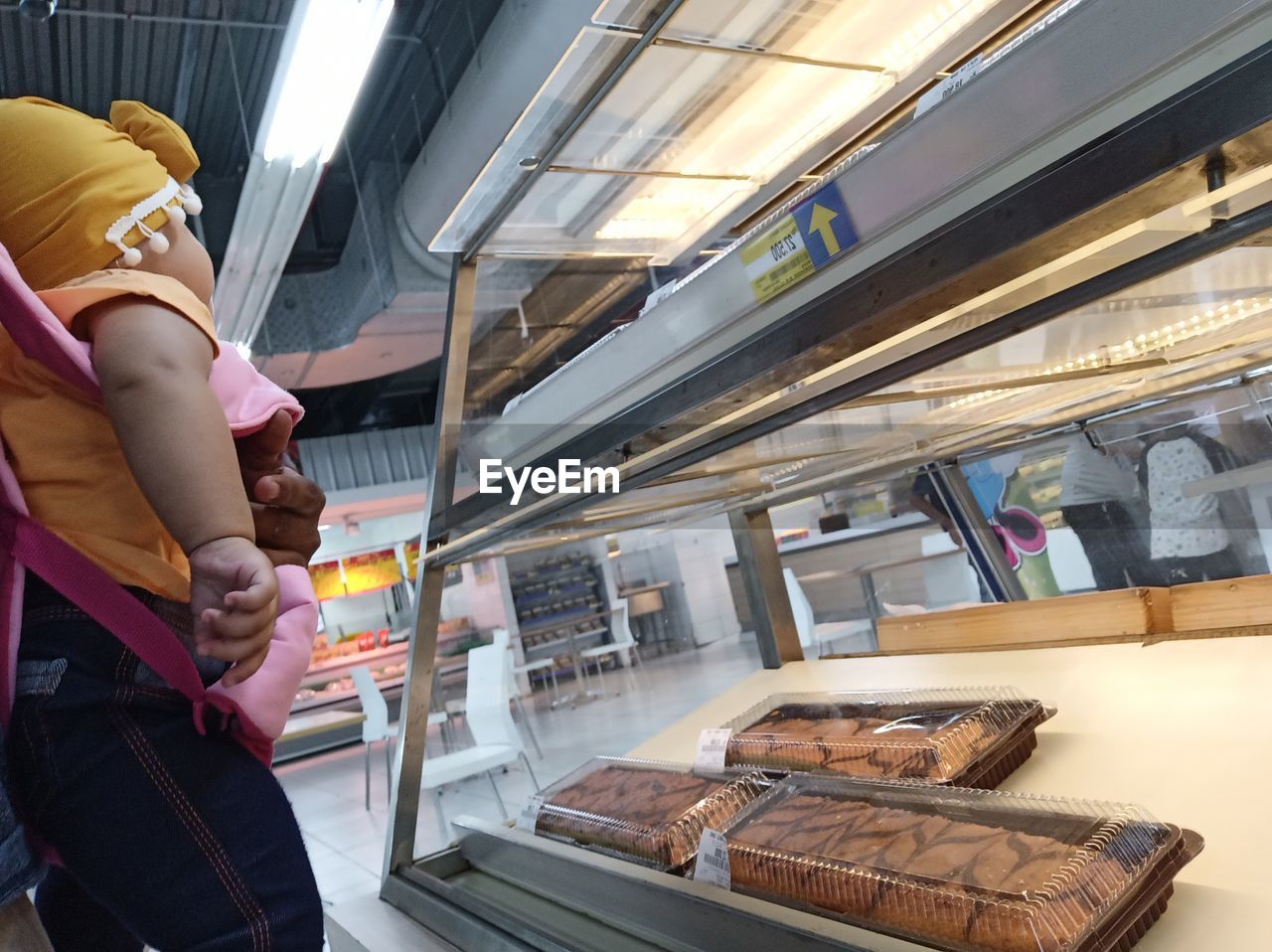 MIDSECTION OF WOMAN STANDING BY TRAIN AT BUS