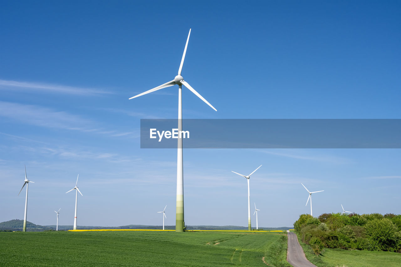 Modern wind energy plants with green fields seen in germany