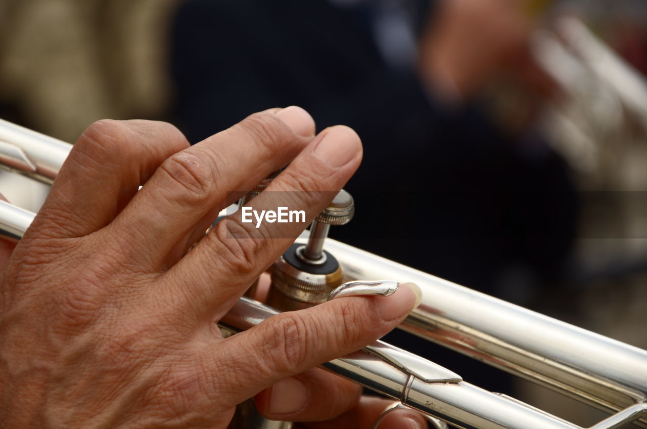 Cropped image of hand playing bass instrument