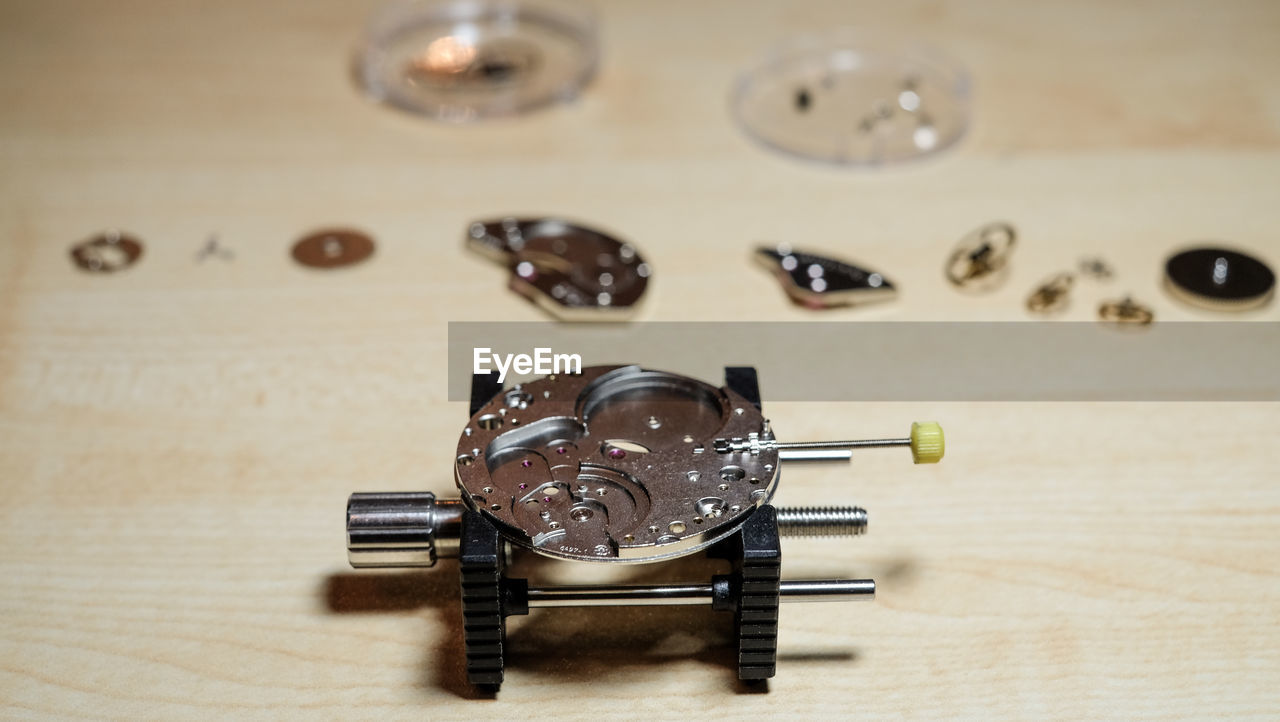 Watch mechanism on wooden table