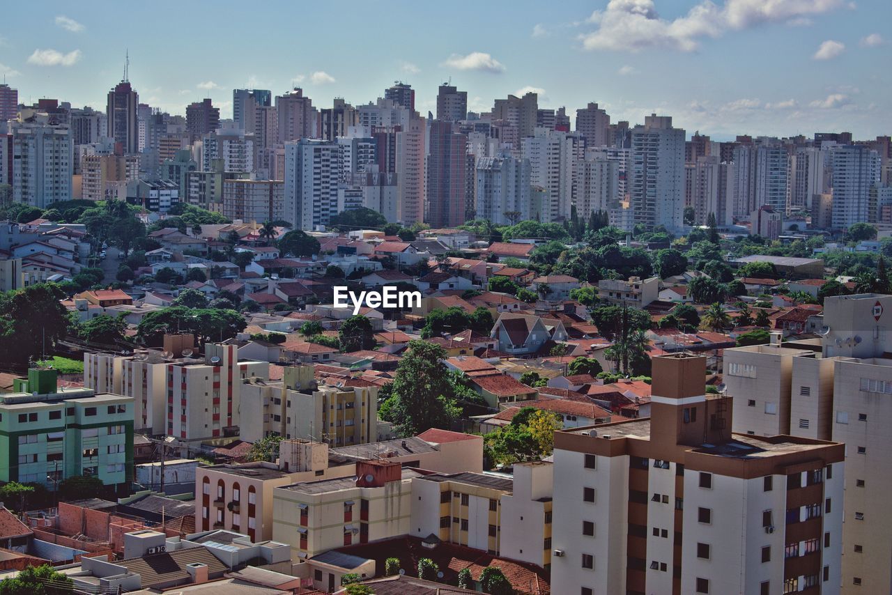 High angle view of buildings in city against sky